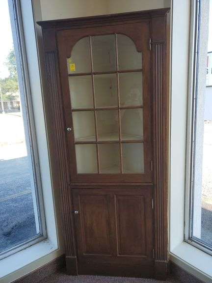 Wood corner cabinet features 12 glass panel door with 4 shelves, lower 2 shelf storage and column mill work. Measures 37 in W X 83 in H.