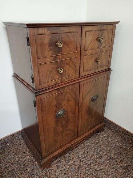 Vintage rosewood dry bar on casters measures 30 in W X 16 in D X 44 in H. Features brass pulls and key for the lock.