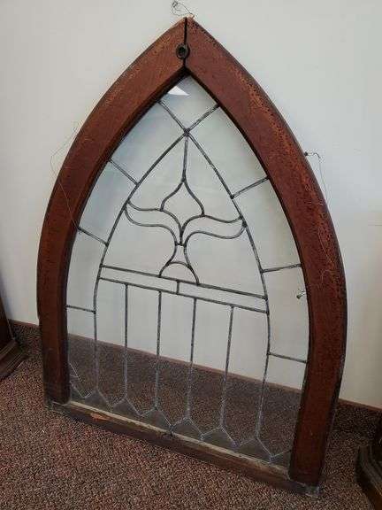 Vintage arched cathedral leaded glass window featuring clear and etched glass. Measures 46 in HX 35 in W. One cracked glass panel.