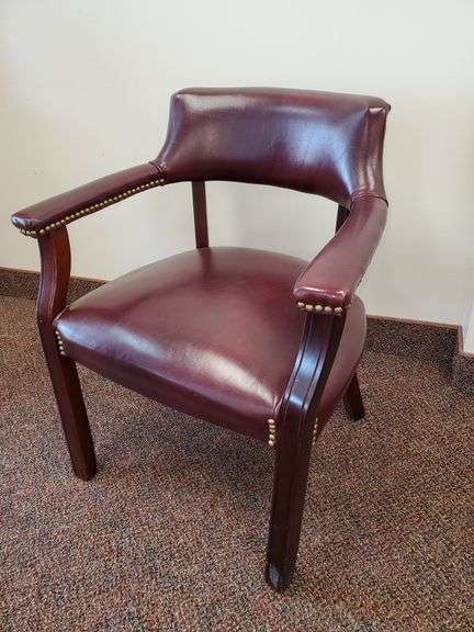 Ox blood red vinyl desk chair with brass button accents