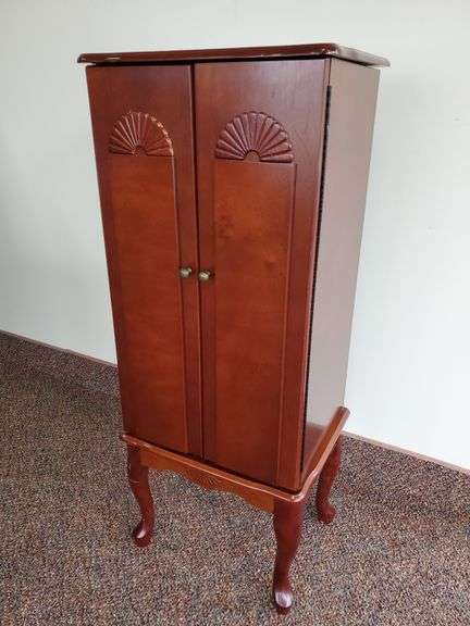 Queen Anne style, cherry finish jewelry cabinet measures 16 in W X 13 in DX 40 in H.