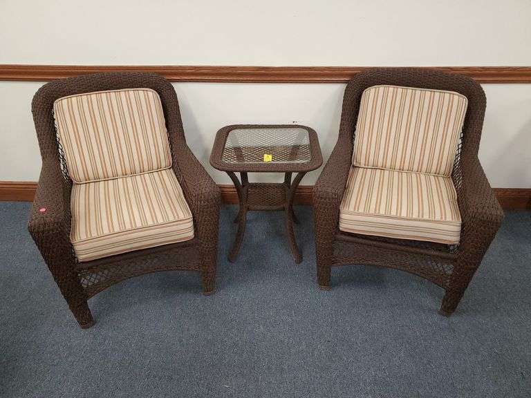 Wicker chairs and glass top table set features aluminum frame and includes reversible chair cushions. See photos