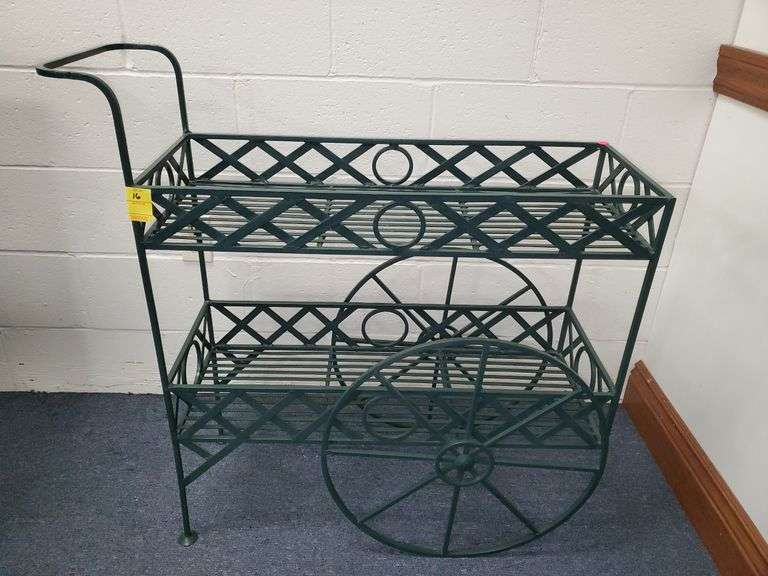 Cast iron rolling plant stand measures 36 in W 12 in D X 35 in H.