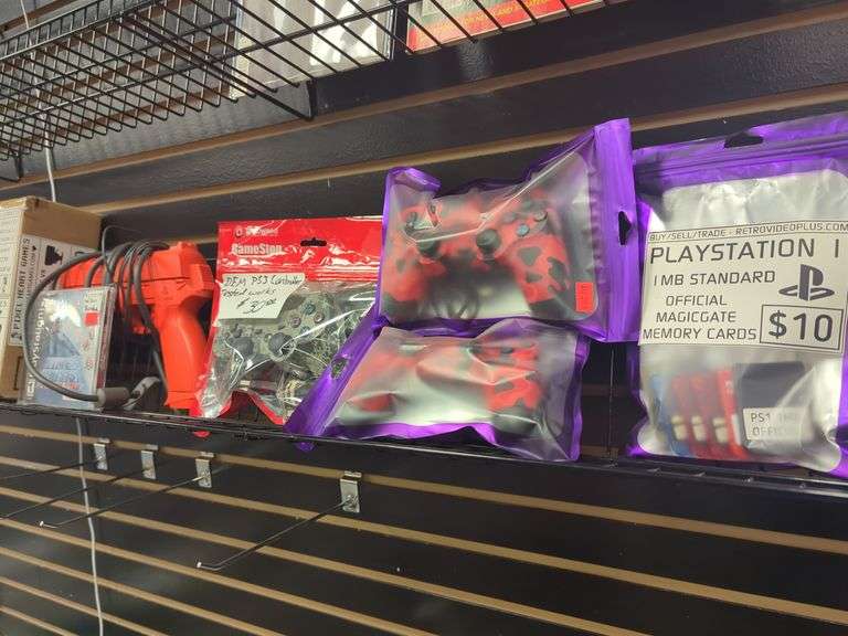 Grouping of PlayStation related including two PS4 red camo controllers one PS3 camo controller, PlayStation Time crisis project Titan with gun, accessory bundle.