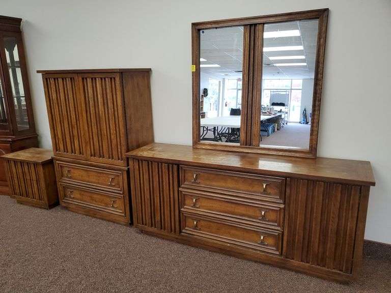 Three-piece vintage solid wood bedroom set including mirrored 9 drawer dresser measuring 73 in W x19 in D and 72 in H. Wardrobe cabinet with upper shelves and lower drawers measuring 40 in WX 19 in D x 58 in H and two drawer nightstand measuring 26 in WX 17 in dx23 in H.