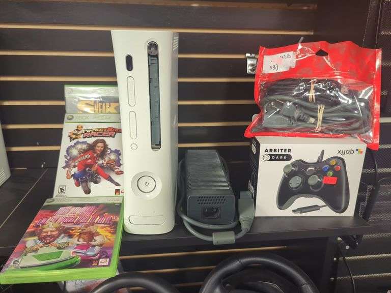 Xbox 360 video game console with power supply, controller, AV cord, three games including big bumping, pocket bike racer, sneak King. Untested. Missing disc cover on console