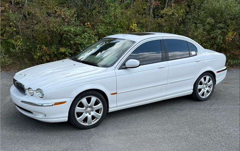 2004 Jaguar X Type, AWD, 3.0 V6, auto trans, 4 door sedan with 81,675 miles ,VIN: SAJEA51C24WD70138,white exterior, saddle color interior, tinted windows ,good tires, front seat covers over worn leather seats. Seller just spent over $2.000.00 for tune up, oil change, and once over inspection. Car starts, runs and drives as it should.