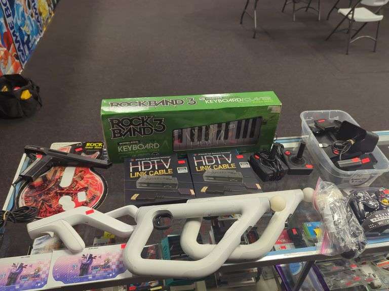 Random grouping of video game accessories including PlayStation guns, Wii controller, Nintendo switch parts, Atari joysticks, HDTV Link cables, Sega light phaser 3050, more. See photos