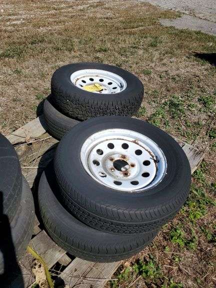 (4) 5 bolt, 15-in, trailer wheels with tires. Tire sizes are (2) p 205/75R15 and (2) p205 70 r 15. See photos