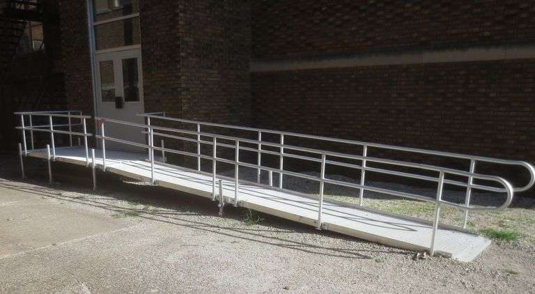 TJ Rampit USA, Inc. aluminum platform access ramp with mounting hardware and rails. Main platform measures 66 in wide X 120 in long, (2) ramp run sections measuring 36 in wide X 120 in long. See photos. Inspect at preview. Needs a good cleaning but solid otherwise.