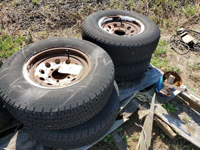 (4) 15 inch, 6 bolt, trailer wheels with tires. Tire size is ST 225/75R15. See photos. Also includes some wiring and brackets.