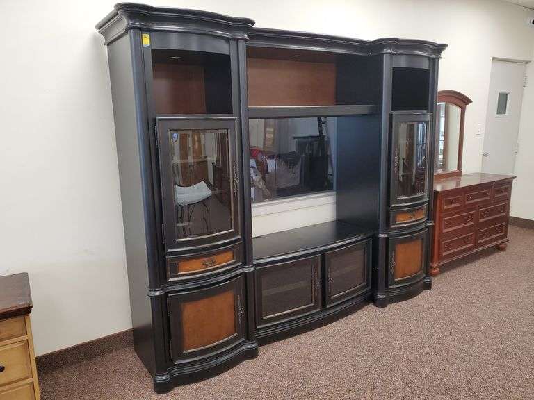 Audio/video/display cabinet with stained wood accent panels, beveled edge curved glass door fronts, brass hardware and lighted upper display shelves. Measures 96-in WX24-in D X 83 in H.
