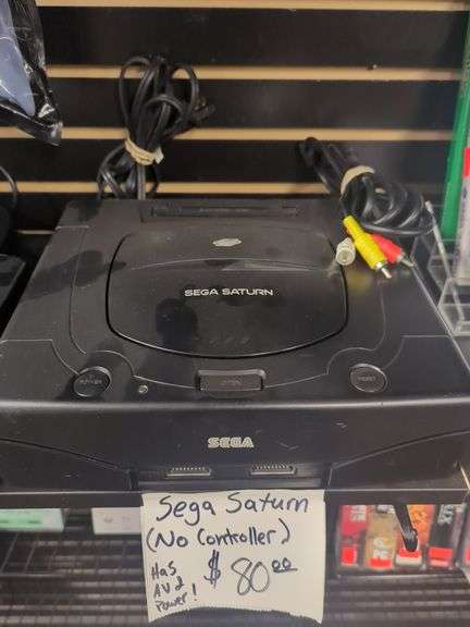 Sega Saturn video game console. Has av2 power. Includes power cord and video cable. No controller. Untested