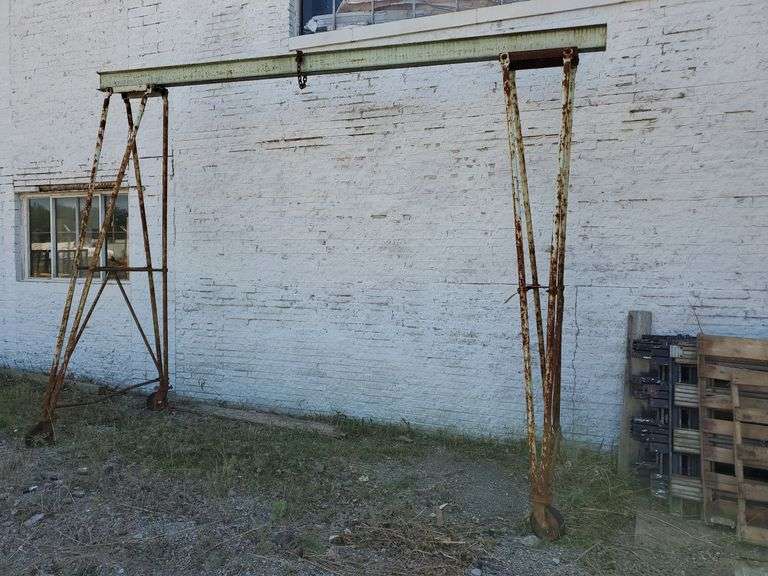 Budgit Gantry A-Frame, model# 502076, manufactured by Manning, Maxwell & Moore Incorporated. Capacity with 8-in beam is 2 tons, capacity with 6-in beam is one ton. Measures 155 in wide X 60 in deep x 125 in tall. Top beam may need removed to fit on trailer. Inspect at preview.