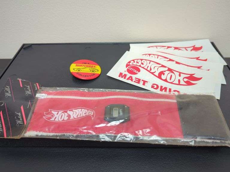 Group including Hot Wheels watch made in Hong Kong, matchbox collector pin, four Hot Wheels iron-ons. All for your bid