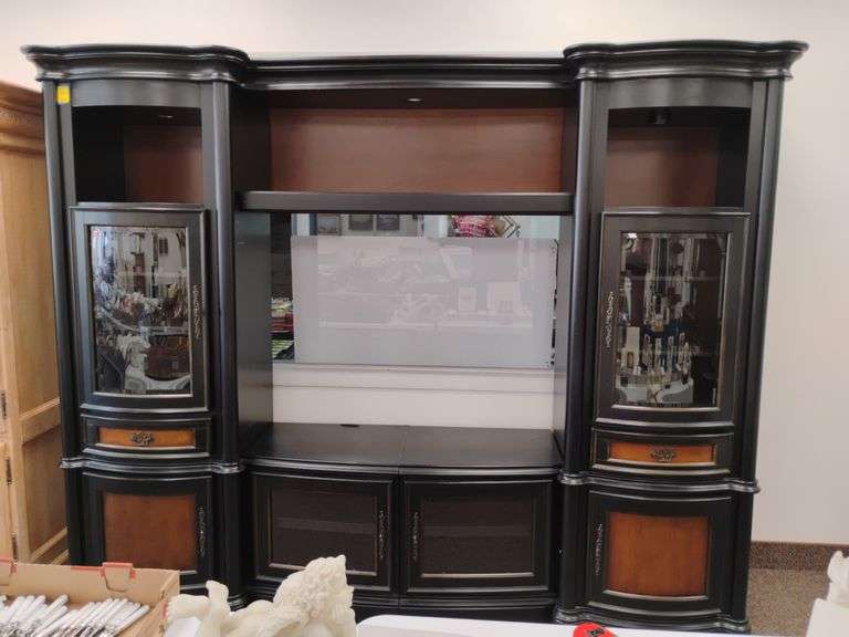 Black lacquer finish entertainment center / bookcase with lights.  Comes apart in four sections for easy moving. Measures 102 in w x 24 in.  D x 82 and 1/2 in. H. Lots of storage.