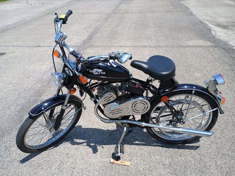 2006, Whizzer Panther, features a 148cc, 4 stroke engine, an automatic centrifugal clutch, belt drive system. Shows 28.3 hours of drive time and 1,287 miles on the odometer. Both are after market pieces along with the Harley Davidson leather satchel bag under the back of the seat. Top speed is approximately 40 mph. Tank appears clean. Also includes box with extra belts, oils, side mirrors, light bulbs and various other items for maintenance of bike.