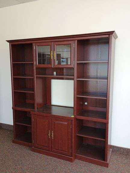 Sauder display/audio/video/gaming center features solid brass hardware, top shelf lighting cut glass doors, and adjustable shelves. Measures 70 inches w x 20 in d x 80 in H.