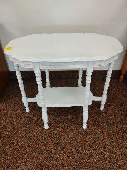 Antique six leg table with a painted white finish. Approximately 34 and 1/2 in w x 20 and 1/2 in D x 29 in H.