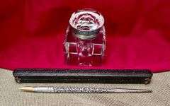 Old ink well and silver pen