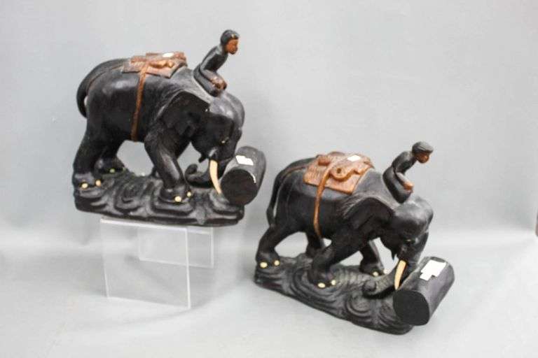 Beautifully carved wood statue of a man riding an elephant rolling a ...