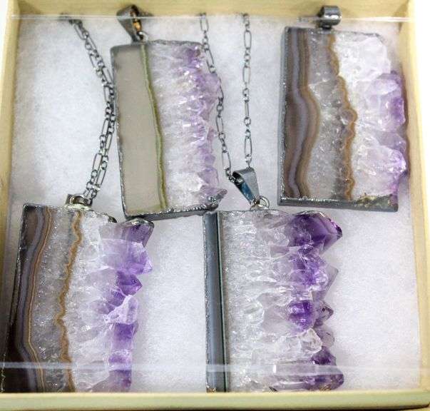 Raw edge cut Amethyst quartz fashioned as Pendants. Four pieces  with four gift boxes.