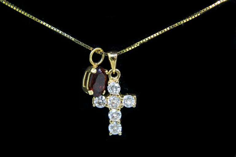 14 KT Gold Necklace with a 14 KT Gold Cross Pendant set with Diamonds (tested) and a second Pendant with a red stone.    ( 2.2 gms t.wt)