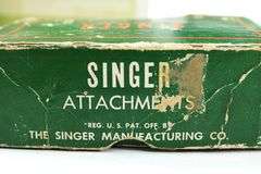 Singer Sewing Machine- Accessories for vintage Singer Sewing Machine, including Zig-Zag instruction manual, Automatic Zig-Zagger, Pinking Shears, and attachments.