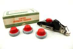 Singer Sewing Machine- Accessories for vintage Singer Sewing Machine, including Zig-Zag instruction manual, Automatic Zig-Zagger, Pinking Shears, and attachments.