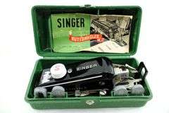Singer Sewing Machine- Accessories for vintage Singer Sewing Machine, including Zig-Zag instruction manual, Automatic Zig-Zagger, Pinking Shears, and attachments.