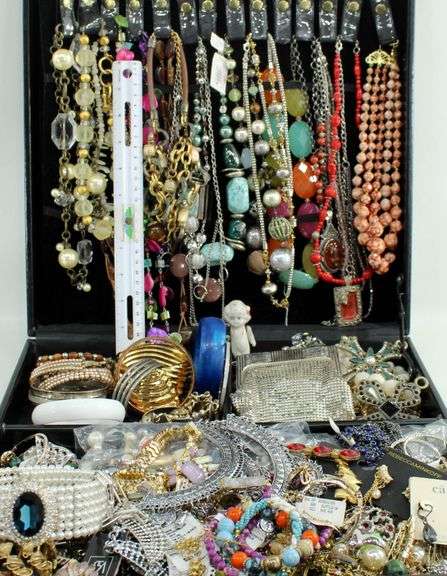 Jewelry and jewelry parts, in a leather travel display case.