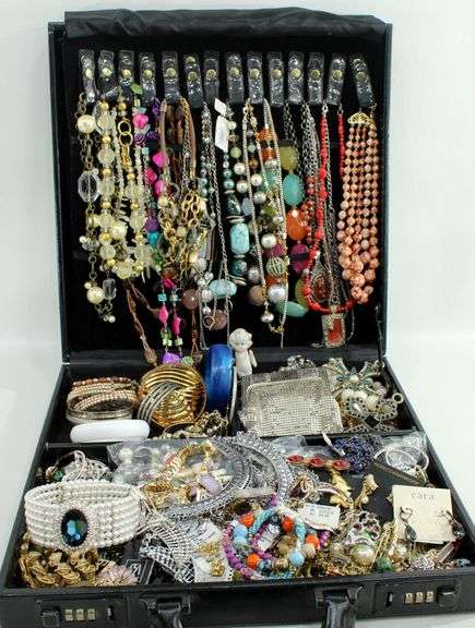 Jewelry and jewelry parts, in a leather travel display case.