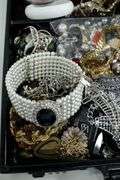 Jewelry and jewelry parts, in a leather travel display case.