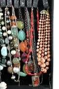 Jewelry and jewelry parts, in a leather travel display case.