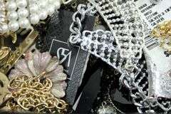 Jewelry and jewelry parts, in a leather travel display case.