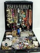 Jewelry and jewelry parts, in a leather travel display case.