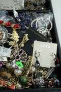 Jewelry and jewelry parts, in a leather travel display case.