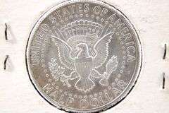 1964 Kennedy silver half dollars and a 1943 Washington Silver Quarter