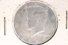 1964 Kennedy silver half dollars and a 1943 Washington Silver Quarter