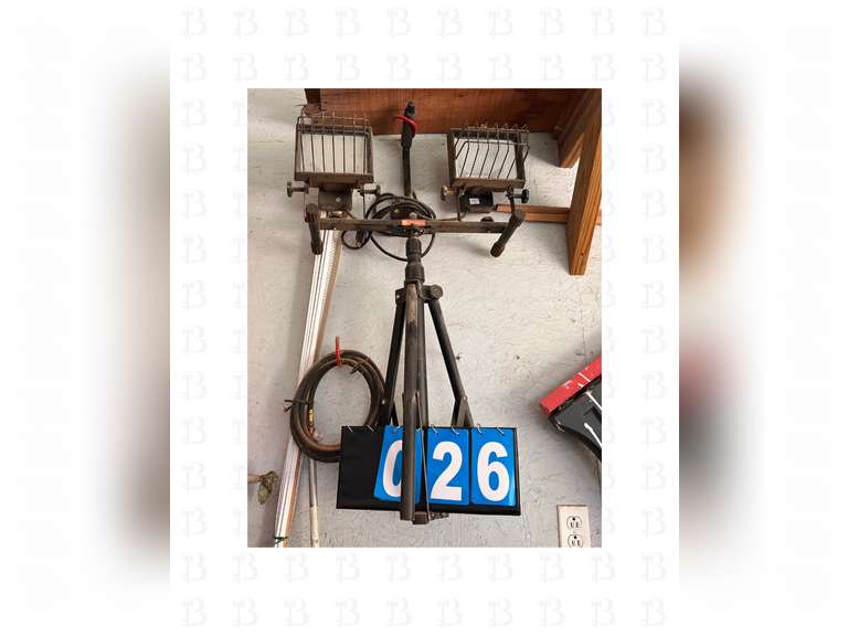 A pair of sawhorses, a 8ft ladder, and construction light with stand.