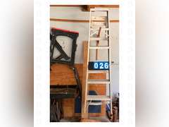 A pair of sawhorses, a 8ft ladder, and construction light with stand.