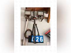 A pair of sawhorses, a 8ft ladder, and construction light with stand.
