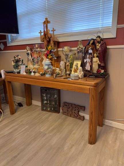 Sofa table and contents ( spoon collection, religious figurines, misc)