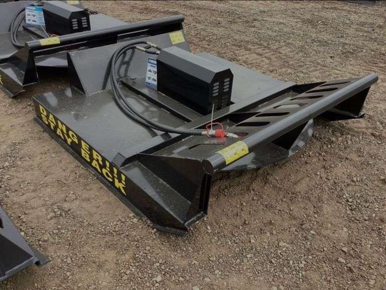 Unused skid steer rotary brush cutter attachment selling at Bonnette Auction Company in Alexandria, Louisiana