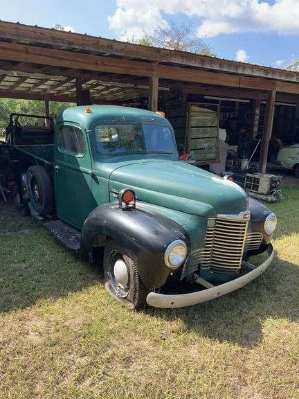 Green 1948 International KB-1 truck, older restoration, parked under a pole barn