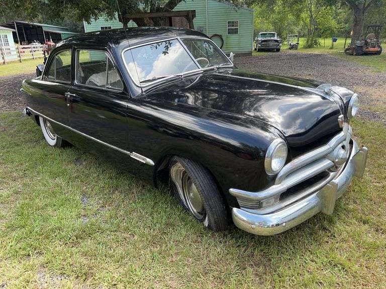 Black 1950 Ford Custom Deluxe with flathead V8 and dual exhaust