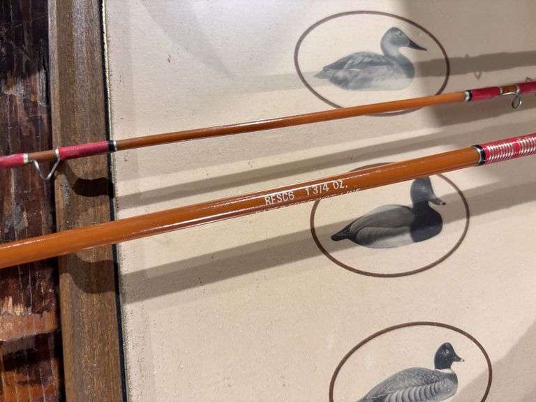 1.75 ounce fishing rod with aluminum container, duck picture, tote, and rope robbers