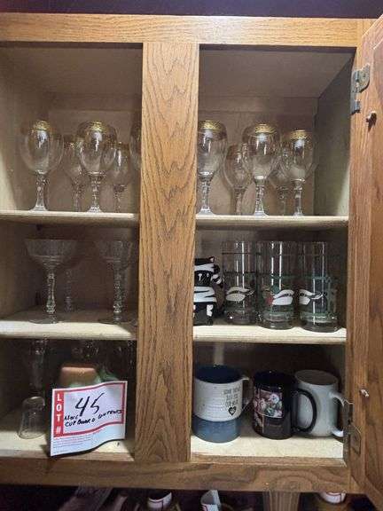 Contents of above cupboards, Cookbook, glassware, mugs, etc.