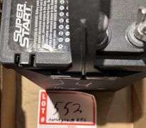 Evanrude Super Fastwin boat motor, battery, and gas cans