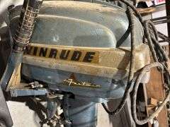 Evanrude Super Fastwin boat motor, battery, and gas cans